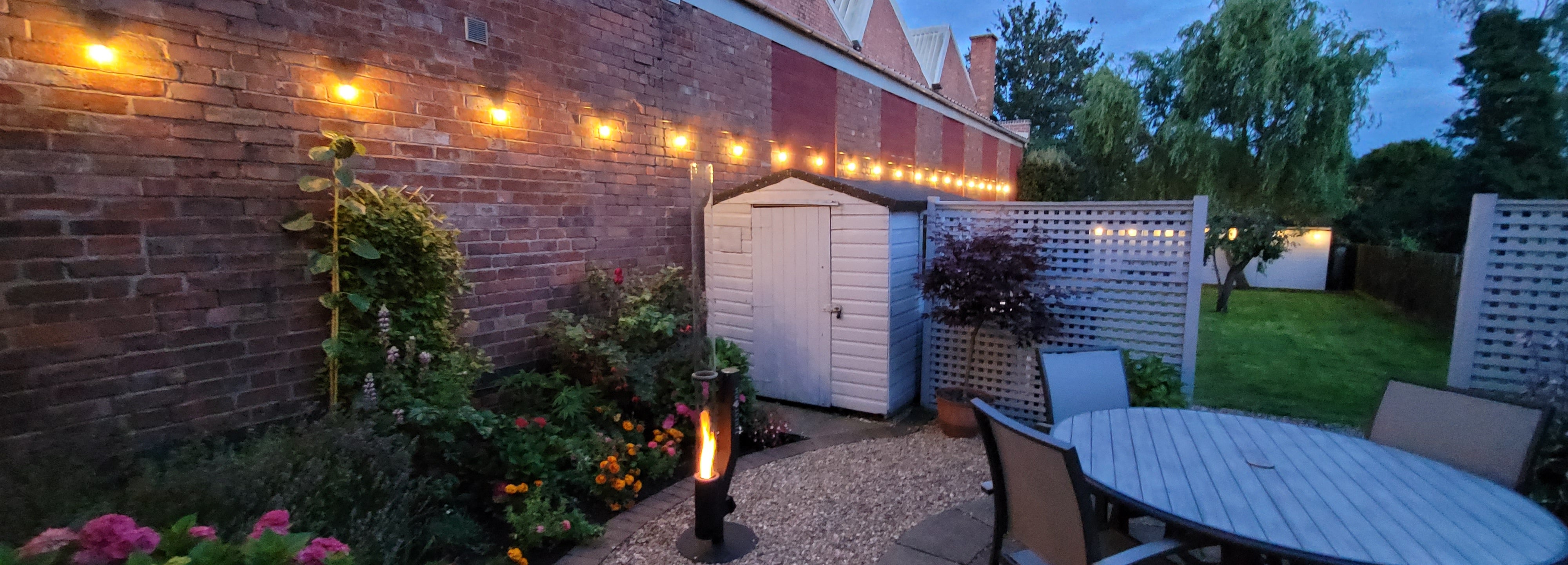 string lighting along a fence with brand logo